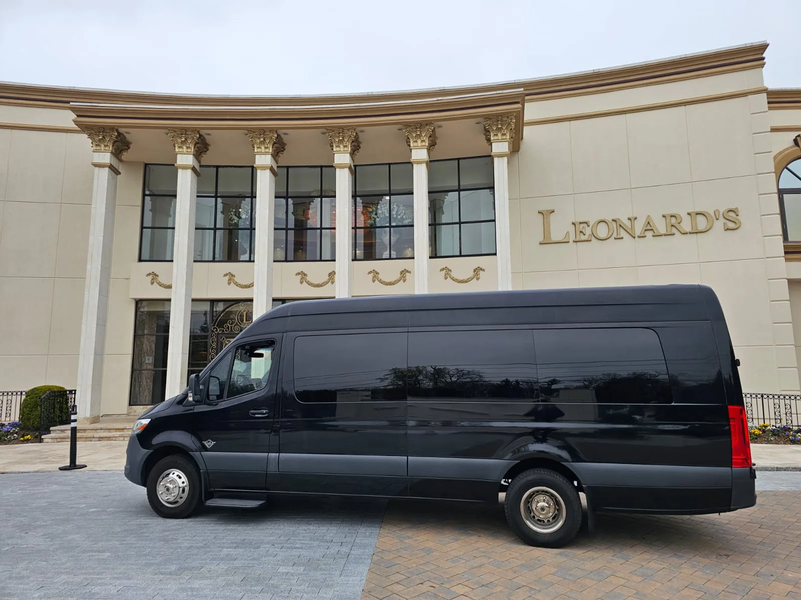 Black Executive Sprinter parked outside a venue